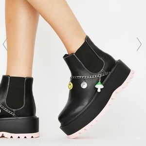 Koi footwear platform boots with charms.